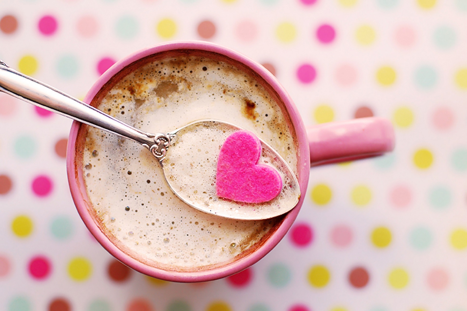 Image: Frothy coffee with heart on a spoon