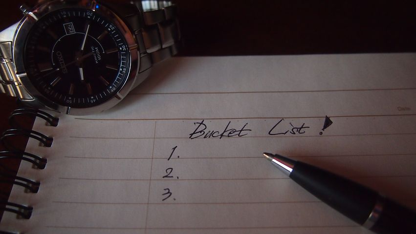 image: bucket list paper pen and watch